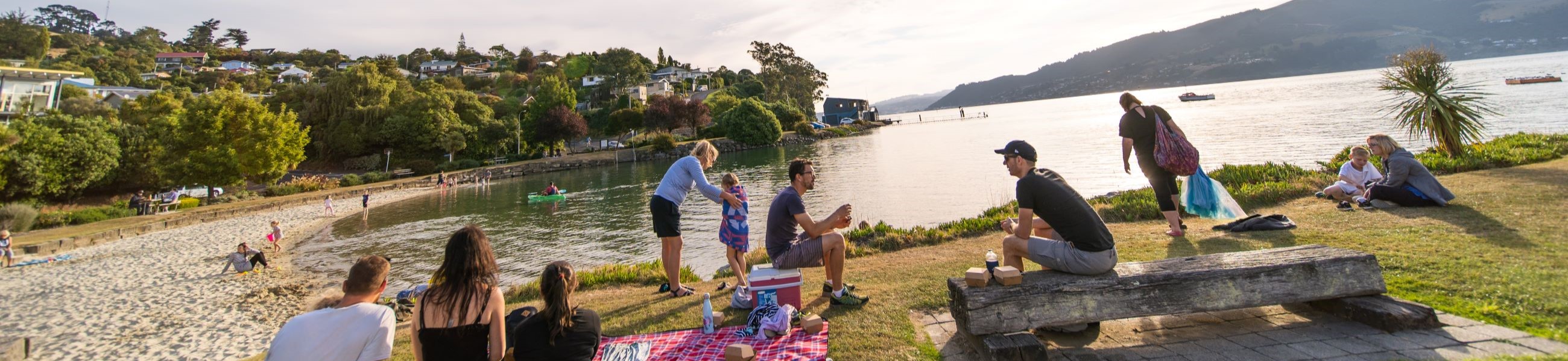 Residents enjoying the summer at Macandrew Bay - promotional image for Dunedin's 