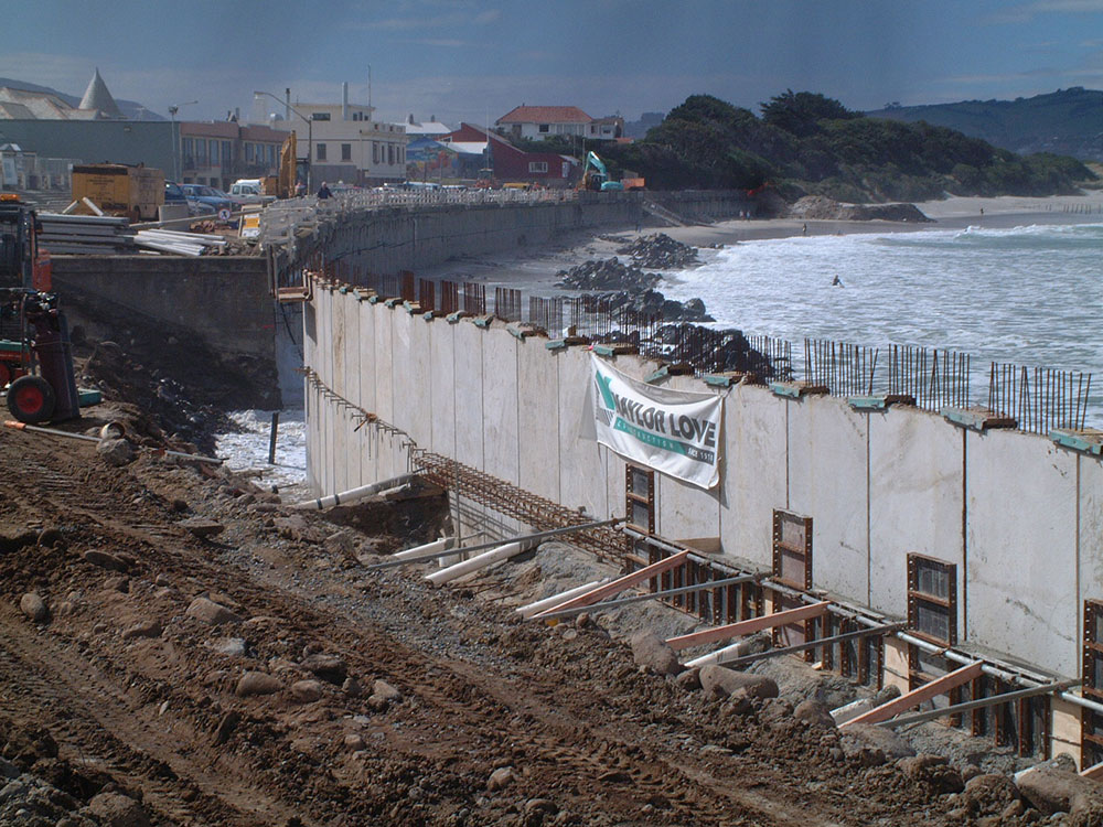 Construction of the current sea wall. The western-end of the sea wall was built a lot further onto the beach than the previous wall