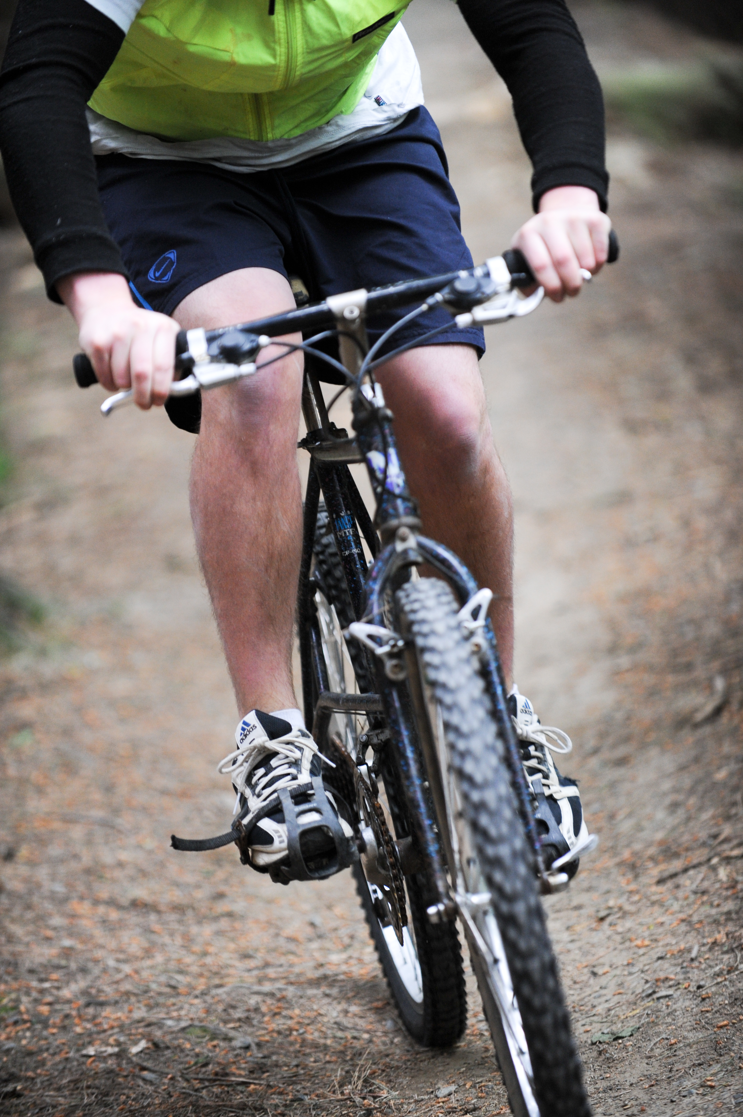 Man mountain biking down Dunedin track